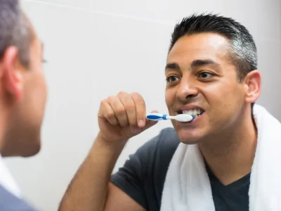 Person Brushing Teeth at Night for Better Oral Health